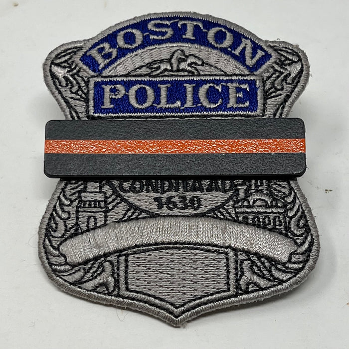 The Stop Gun Violence Wear Orange Awareness / Thin Orange Line Mourning Bars for Cloth Badges and insignia.  Black vinyl with a thin orange line mourning bar with a pair of 1/2" pins with military clasps.  Public safety officers are wearing thin orange line badge shrouds to raise awareness of gun violence in the community and among police officers, firefighters, Emergency Medical Services and others.  J