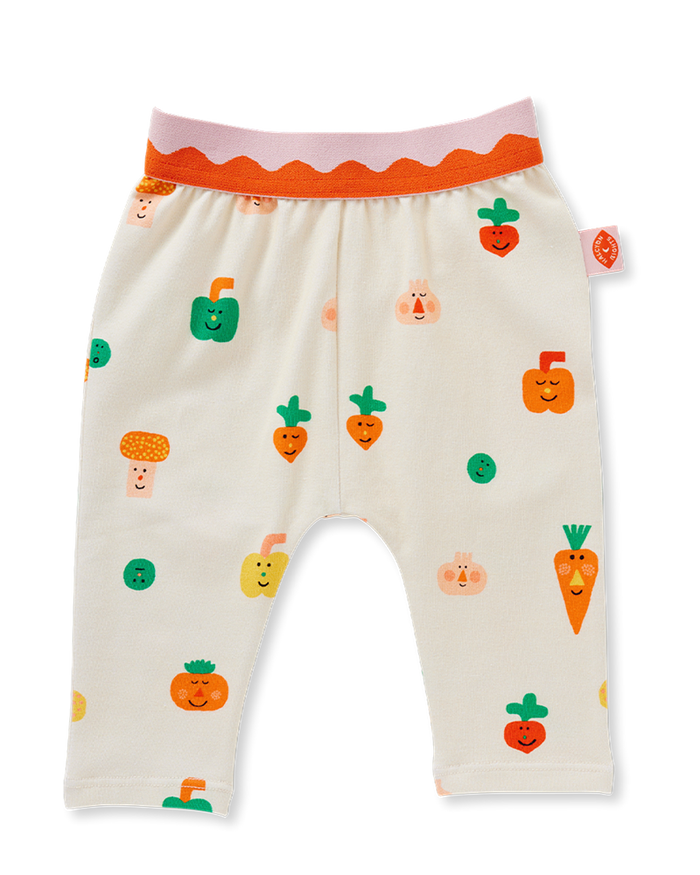 Beige baby pants with colorful vegetable patterns on a white background