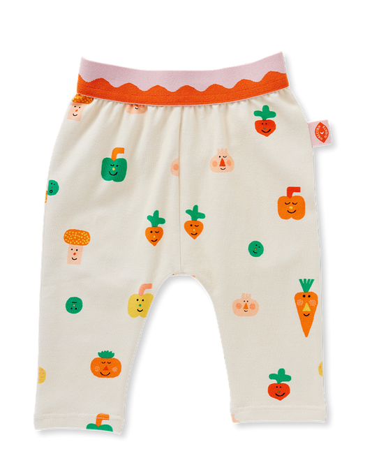 Beige baby pants with colorful vegetable patterns on a white background