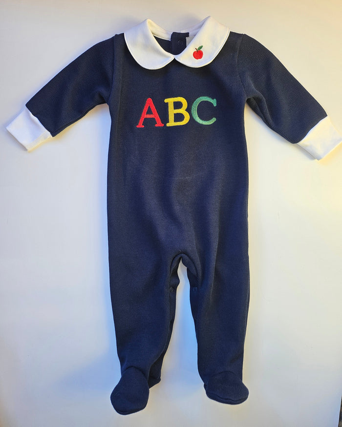 Navy baby onesie with colorful 'ABC' letters on a white background
