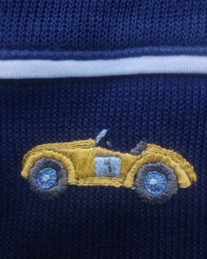 Embroidered yellow car on a blue fabric background