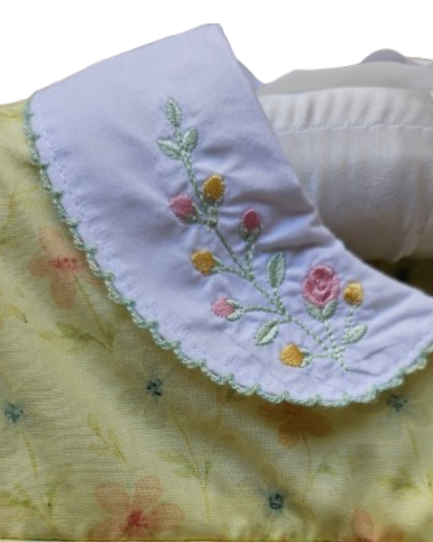 Embroidered floral collar on a yellow fabric background