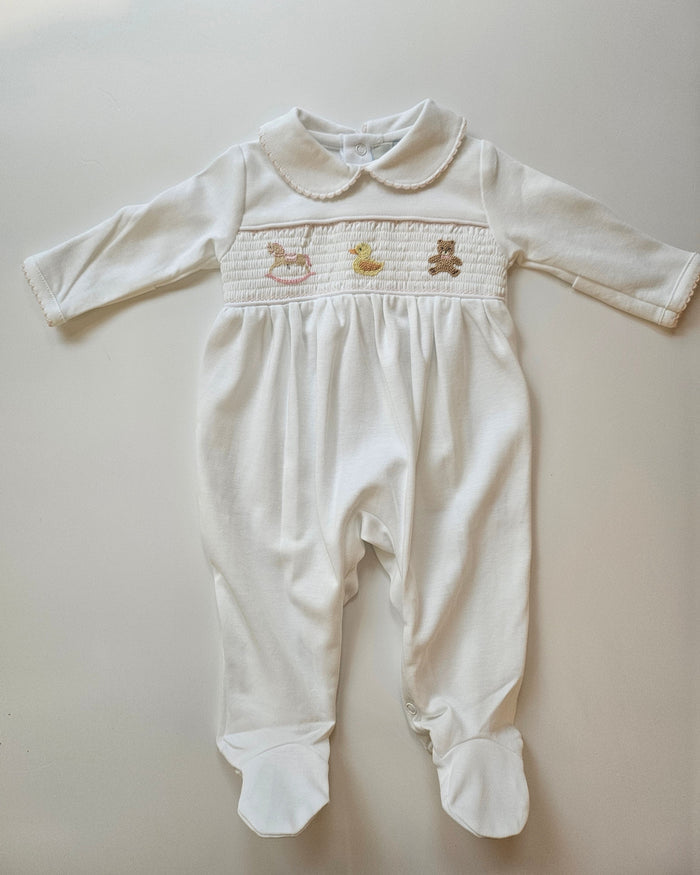 White dress with embroidered details on a light gray background