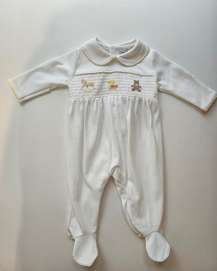 White baby outfit with long-sleeve top and pants on a light gray background
