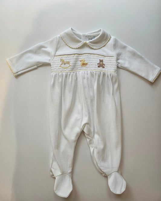 White baby outfit with long-sleeve top and pants on a light gray background