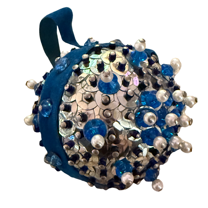 Vintage silver sequin ball ornament with blue and navy beads, pearl-look accents, a floral bead motif, and a blue velvet hanging loop.