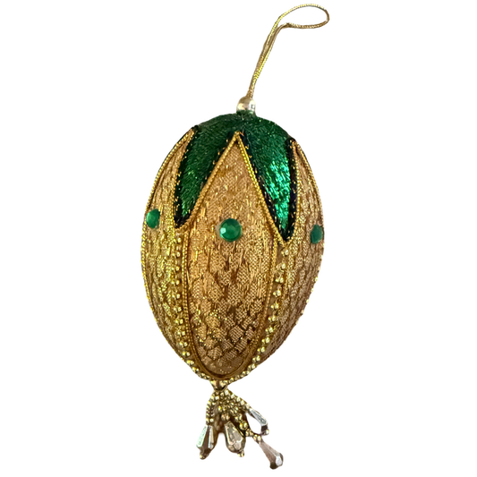 Elongated vintage gold ornament with emerald green accents, green jewel-look embellishments, gold-tone beaded trim, and dangling faceted drops.