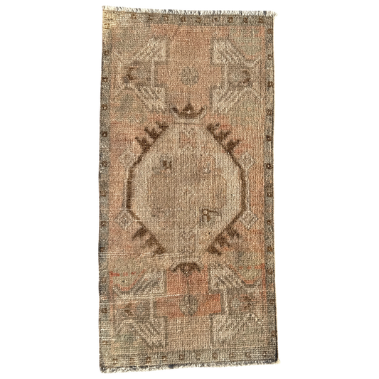 Rectangular vintage-style rug with intricate patterns on a white background