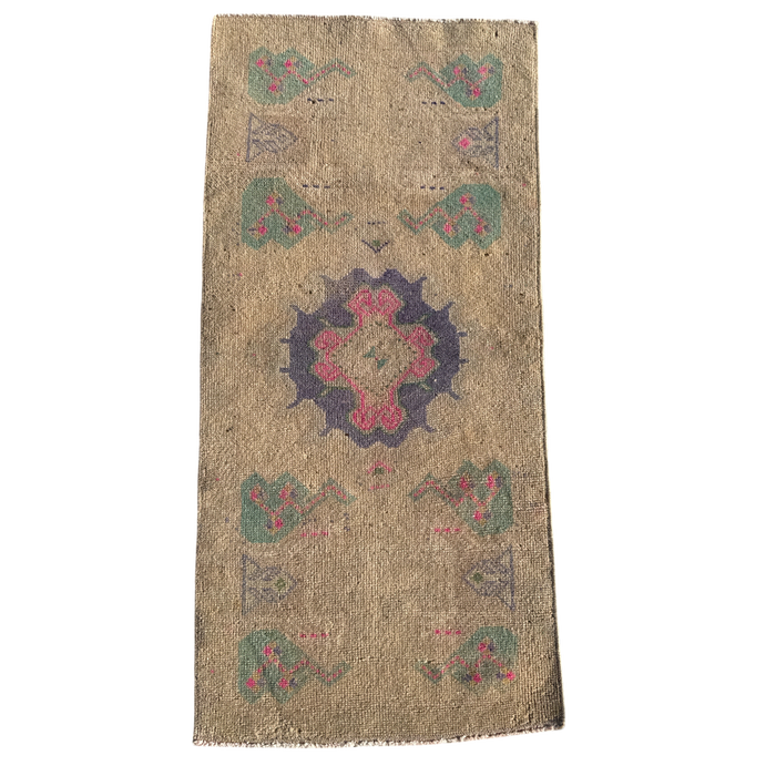 Decorative rug with a central floral design on a beige background