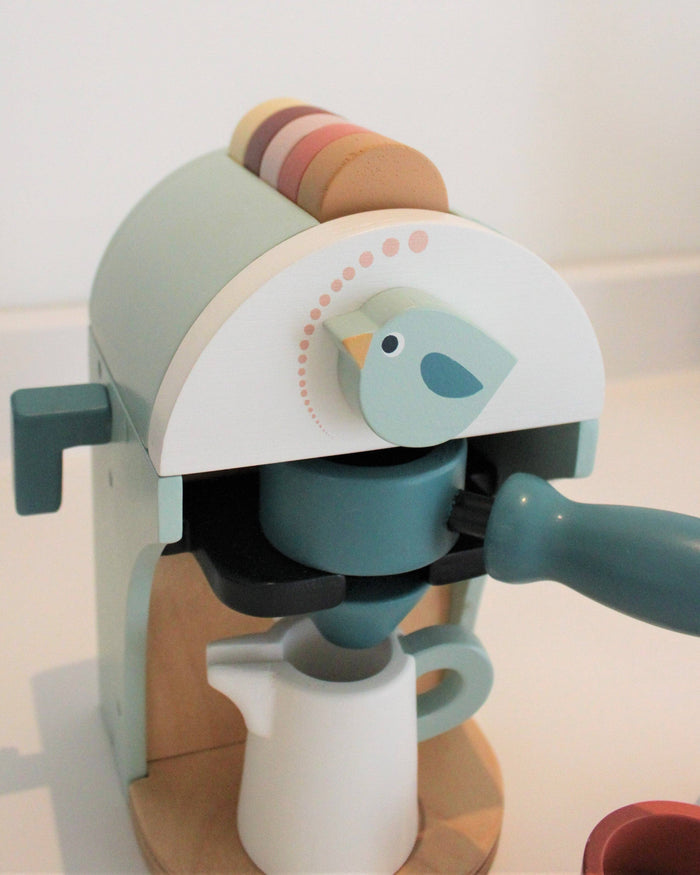 Children's toy coffee maker with a bird design on a light background