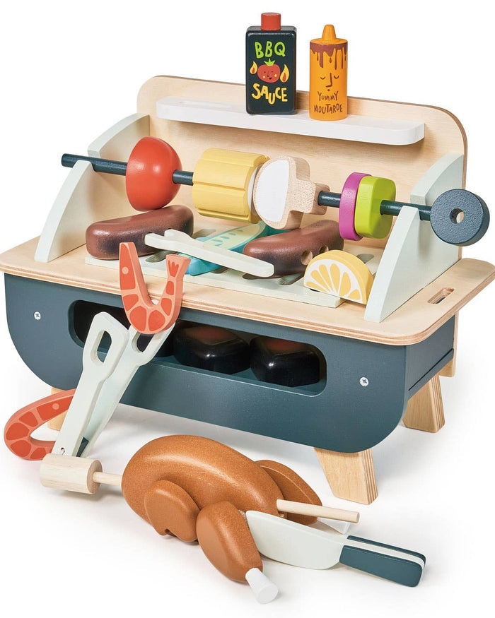 Toy barbecue set with various accessories on a white background