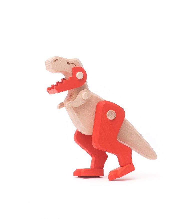 Wooden toy dinosaur with a red shell on a white background