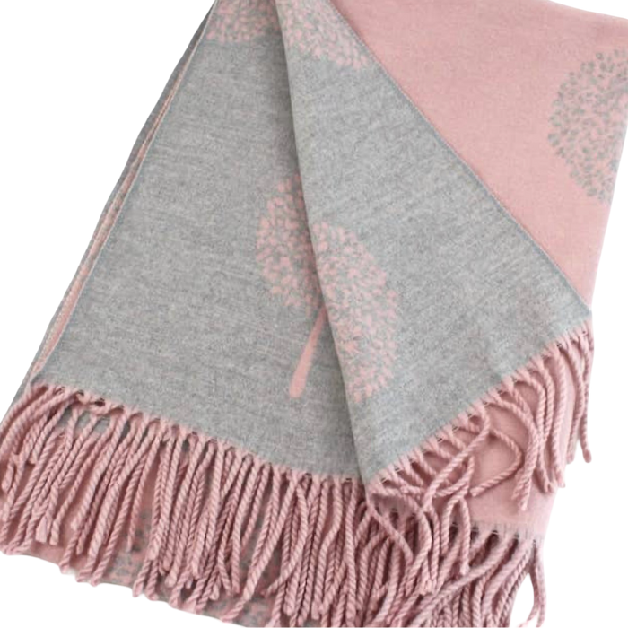 Dusty pink and gray reversible scarf folded to show contrasting tree motifs on both sides, with pink fringe at the ends.